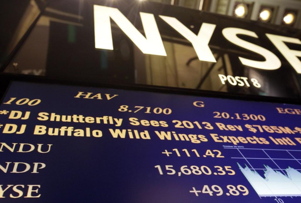 A board on the floor of the New York Stock Exchange shows Tuesday’s record-high closing number – 15,680.35 – for the Dow Jones industrial average.