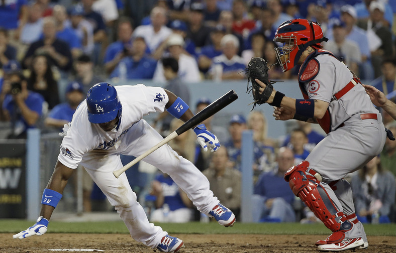 Yasiel Puig of the Los Angeles Dodgers gets out of the way of an inside pitch Tuesday night as catcher Yadier Molina of the St. Louis Cardinals receives the ball in the fourth inning of the Cardinals’ 4-2 victory in Game 4.
