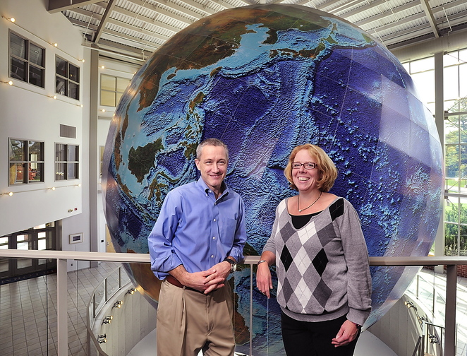 Jim Shillings, vice president of commercial products, and Shannon Garrity, data production manager, talk about the future of DeLorme in front of Eartha, the massive globe that was recently refurbished,