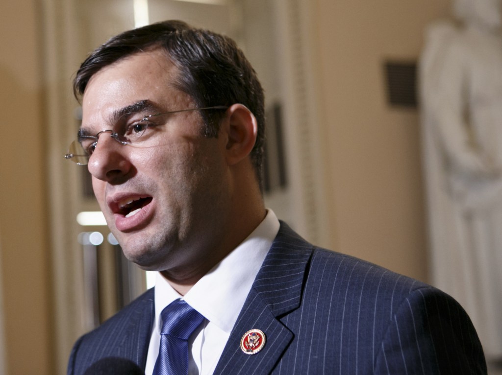 In this July 24, 2013 file photo, Rep. Justin Amash, R-Mich. speaks on Capitol Hill in Washington. Hard-line House Republicans are dismissing dire warnings that a government default would wreck U.S. and world economies as another case of hyperbole from an Obama administration that cried wolf about the likely impacts of automatic spending cuts and partially shutting down the government.