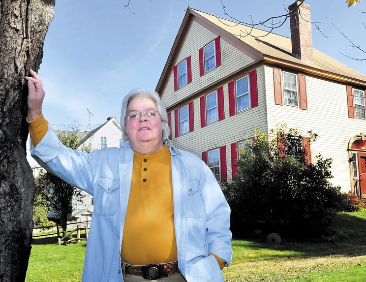 Marty Golias, originally from Salem, Mass., stands in front of her home on the Falls Road in Benton where she has lived for 13 years. She believes that the house, which is described as haunted in Tom Verde’s book “Maine Ghosts and Legends,” is home to friendly spirits.