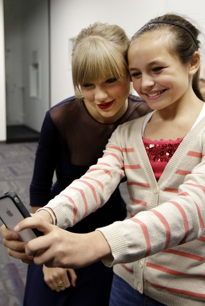 Taylor Swift poses for a photo with Piper Moralez, 11, at the Country Music Hall of Fame and Museum on Saturday in Nashville, Tenn. Swift was thereto open the $4 million Taylor Swift Education Center.