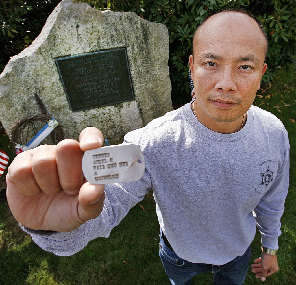 Peter Nguyen of Plymouth, Mass., holds a military dog tag bearing the name of Angel Torres. Nguyen, who lost his father in the Vietnam War, says he will fly anywhere to give the tag to its owner or to relatives of the owner. Clues on the tag suggest that Torres may have been from New England.