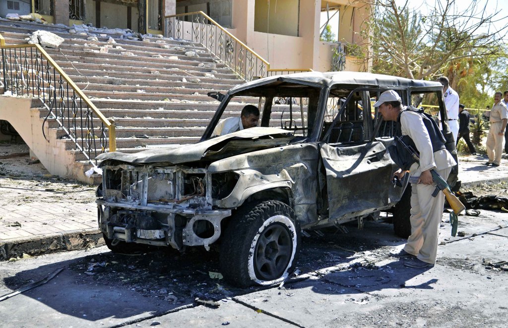 Egyptian security forces inspect the site of a suicide car bombing on a security headquarters in the southern Sinai town of el-Tor, Egypt, on Monday.