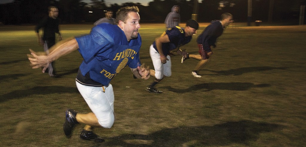 Mike Wolongevicz runs a drill with the Coastal Chiefs football team in Hanover, Mass. He’s 42 years old, just 5 feet seven inches tall and overcame what seemed like unsurvivable injuries a decade go. He’s also a force on the football field.