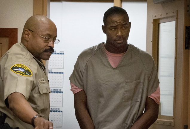 Jeremiah Hill, 23, right, is escorted by a corrections officer at his arraignment Tuesday in Pierce County Superior Court in Tacoma, Wash.. Hill is charged with first-degree murder in the stabbing death of Spc. Tevin Geike, 20.