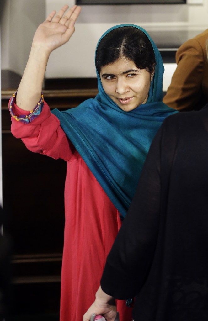 Malala Yousafzai waves to the media after posing for photographs on Thursday in New York. Yousafzai, who was shot by the Taliban for her advocating education for girls, has won the $65,000 Sakharov Award, Europe’s top human rights award.