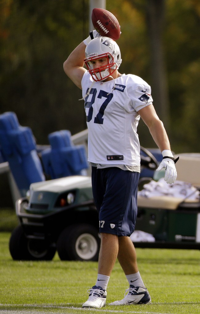 New England Patriots tight end Rob Gronkowski throws a football during a stretching and drills session before NFL football practice begins at the team’s facility in Foxborough, Mass., Wednesday, Oct. 9, 2013. The Patriots host the New Orleans Saints on Sunday.