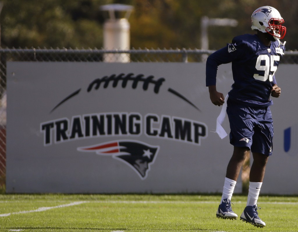 New England Patriots defensive end Chandler Jones (95) jumps during a stretching and drills session before NFL football practice begins at the team’s facility in Foxborough, Mass., Wednesday, Oct. 9, 2013. The Patriots host the New Orleans Saints on Sunday.