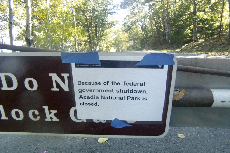 A sign on a closed gate near the entrance to the Park Loop Road in Acadia National Park tells visitors Thursday that the park is closed because of the government shutdown.