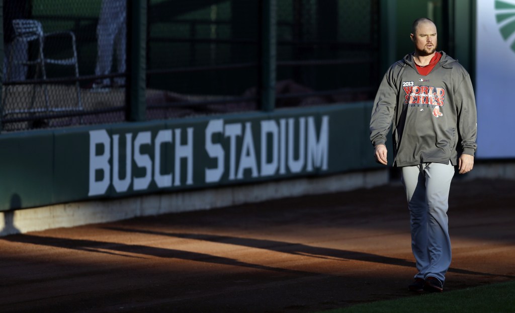 Red Sox pitcher Jon Lester walks in the outfield during practice Friday at Busch Stadium in St. Louis.