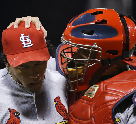 St. Louis Cardinals relief pitcher Carlos Martinez, left, and catcher Yadier Molina react during the eighth inning of Game 2 of baseball's World Series against the Boston Red Sox Thursday, Oct. 24, 2013, in Boston. (AP Photo/Matt Slocum)