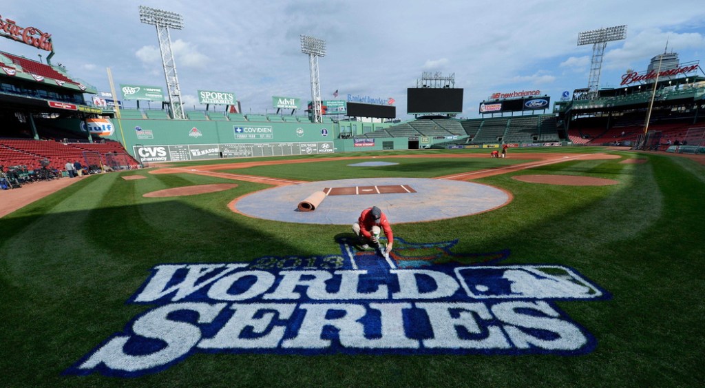 Chris Williams paints the logo Tuesday on the eve of Game 1 of the World Series at Fenway Park, weather permitting. It will be the fourth Series appearance in 10 years for the Cardinals, and the third for the Red Sox.