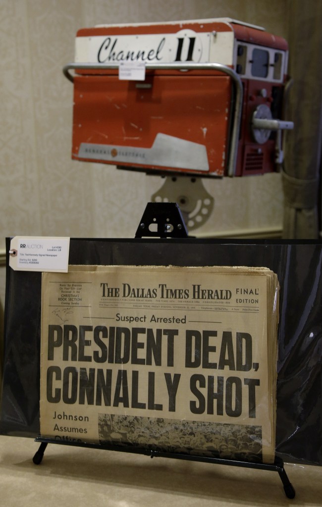 A copy of the final edition of The Dallas Times Herald from the afternoon of Nov. 22, 1963, along with a circa 1960s General Electric television broadcast camera owned by KTVT television in Dallas, Texas. The camera was used by KTVT to record the shooting of Lee Harvey Oswald by Jack Ruby in the basement of the Dallas Police Station on Nov. 24, 1963.