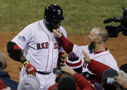David Ross of the Boston Red Sox tugs on David Ortiz’s beard Wednesday night after Ortiz hit a two-run homer in the seventh inning of the 8-1 victory against the St. Louis Cardinals in Game 1 of the World Series at Fenway Park.