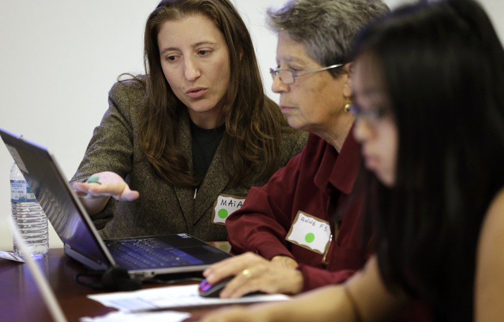Maia Weinstock, left, of Cambridge, Mass., a Brown University graduate, works with Anne Fausto-Sterling, of Cranston, R.I., center, a professor of biology and gender studies, during a Wikipedia “edit-a-thon,” on the Brown campus, in Providence, R.I.