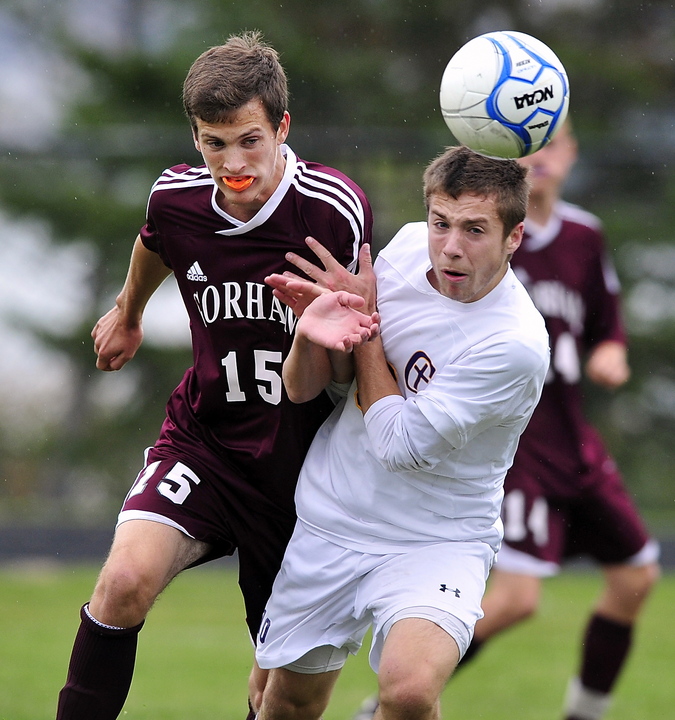 James Biegel of Cheverus, right, heads the ball away from Austin Bell of Gorham at Cheverus High. Gorham will bring a 10-3-1 record into the Western Class A playoffs. Cheverus dropped to 9-4-1.