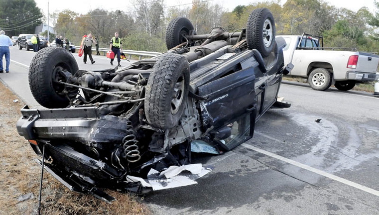 A Jeep Cherokee lies upside down where it landed after plowing into a vehicle on the side of Route 150 in Skowhegan on Thursday. Police said the father and son who were riding in it were not injured in the crash, which involved four vehicles, including two Maine Warden Service trucks. A state game warden, one of two at the scene, suffered minor injuries, police say.