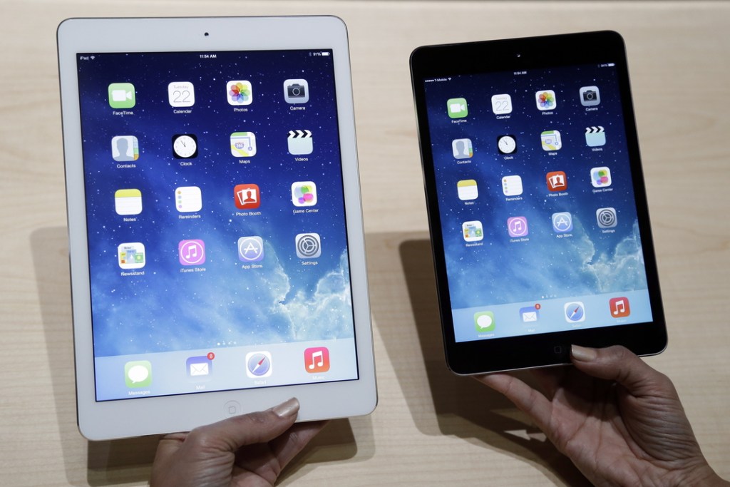 An Apple employee demonstrates the new iPad Air, left, and iPad Mini last week in San Francisco.