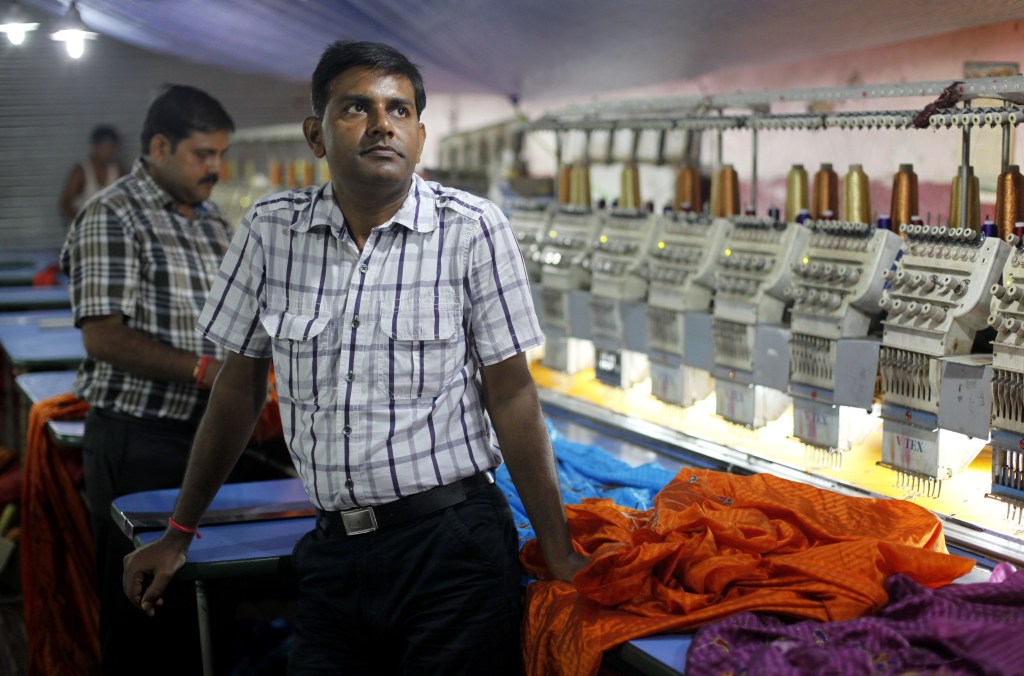 Pradeep Kumar Yadav stands inside his embroidery factory in Varanasi, India, recently. Despite nearly two decades of rapid economic growth, most Indians are risk averse and do not own stocks.