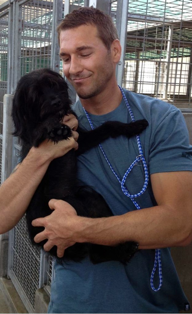 Brandon McMillan, host of the show “Lucky Dog,” picks up a dog at an animal shelter. The show is on Saturday mornings.