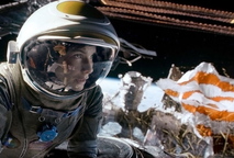 Sandra Bullock and, below, George Clooney find trouble in outer space in “Gravity.”