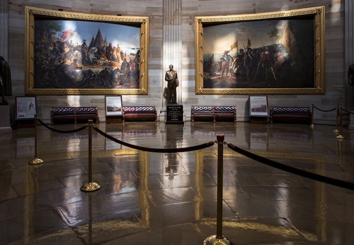 Normally filled with visitors and tourists, the empty Rotunda at the U.S. Capitol is seen in Washington, Tuesday, Oct. 1, 2013, after officials suspended all organized tours of the Capitol and the Capitol Visitors Center as part of the government shutdown. A statue of President Gerald R. Ford at center is illuminated amid large paintings illustrating the history of the United States.