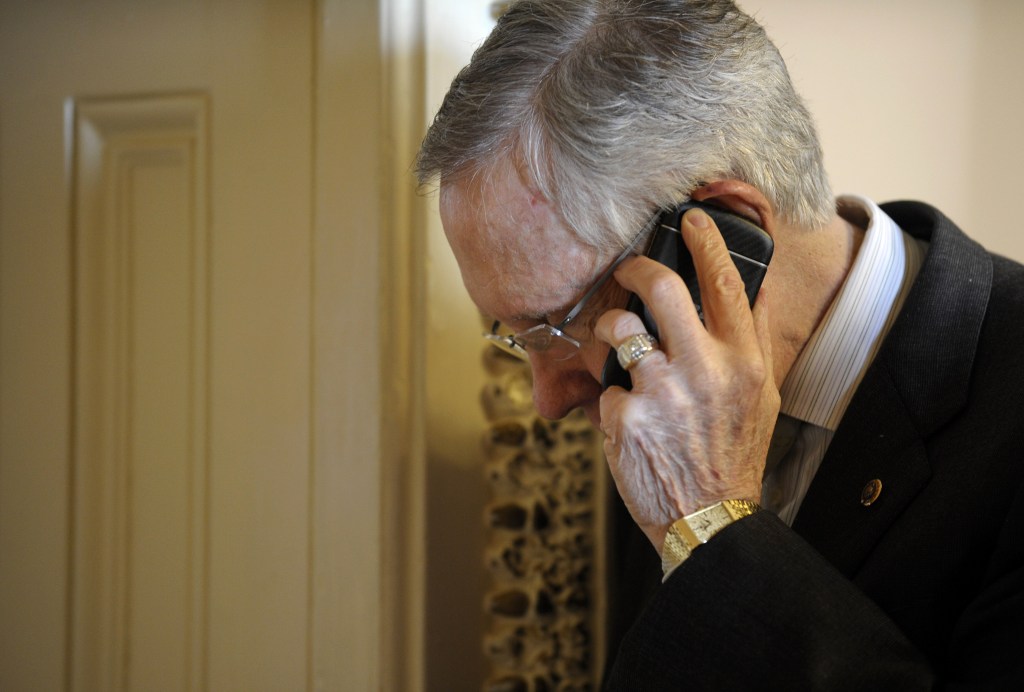 Senate Majority Leader Harry Reid of Nev. talks on the phone after steppng out of a Democratic policy luncheon on Capitol Hill in Washington, Tuesday, Oct. 1, 2013. Lawmakers on Capitol Hill continue to scramble to reach agreement on funding the federal government.