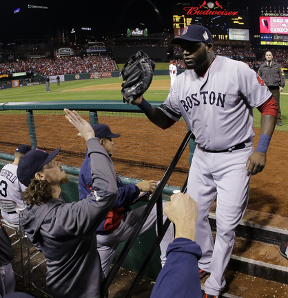 David Ortiz is greeted in the dugout after being pulled for a defensive replacement in the eighth inning Monday night. Ortiz is 11 for 15 in the World Series, a .733 average.