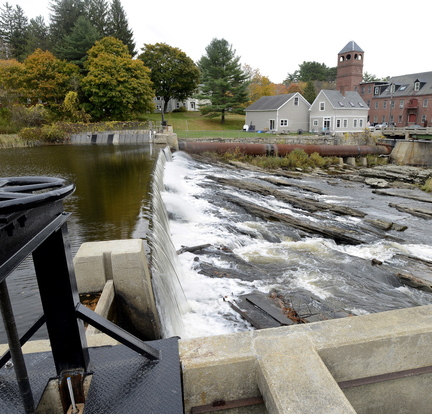 Water from the Royal River flows over the Bridge Street dam in Yarmouth. The dam is one of two dams the town is considering removing from the river.