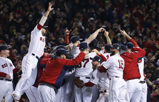 Boston Red Sox players celebrate after defeating the St. Louis Cardinals in Game 6 of the World Series on Wednesday at Fenway Park in Boston.