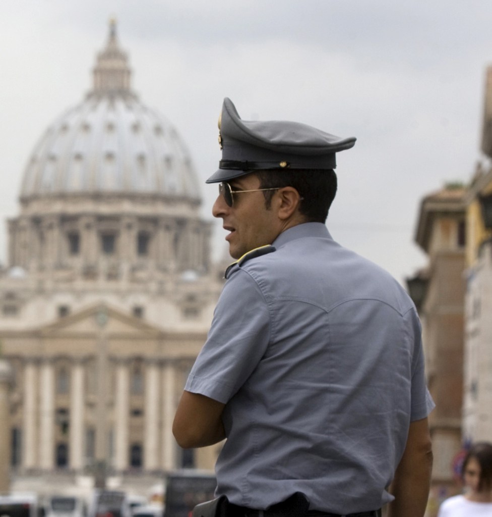 A financial officer stands in front of St. Peter’s Square at the Vatican, which revealed facts about its bank Tuesday.