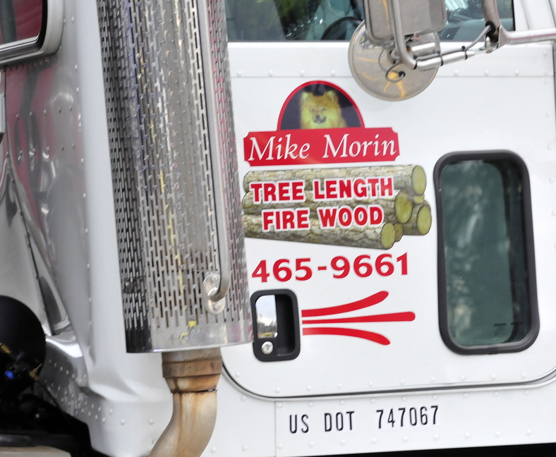 MAN’S BEST FRIEND: A photo of truck driver Mike Morin’s Pomeranian dog is on the side of his truck. Morin was killed when the truck rolled over him before crashing into the Pizza Hut restaurant in Skowhegan on Monday.