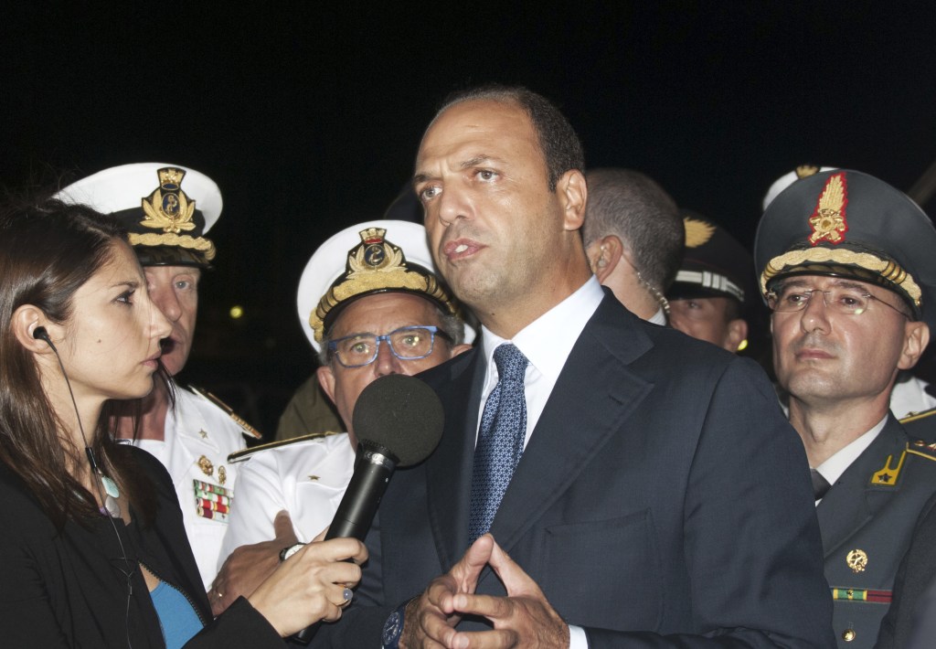 Interior Minister and Deputy Premier Angelino Alfano gives a statement to the press upon his arrival in the Sicilian island of Lampedusa, southern Italy, Thursday, Oct. 3, 2013. At least 114 people died and scores more were missing late Thursday after a crowded fishing boat carrying African migrants from Tripoli caught fire, flipped over and sank, Italian officials said. Hundreds of migrants reach Italy’s shores every day, particularly during the summer when the seas are usually calmer. According to the U.N. refugee agency, 8,400 migrants landed in Italy and Malta in the first six months of this year, almost double the 4,500 who arrived during the first half of 2012.