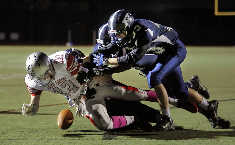 South Portland's Hayden Owen fumbles the ball at the goal line under pressure from Portland's defense including Domenic Fagone, at right, during first-half action at Fitzpatrick Stadium on Friday.