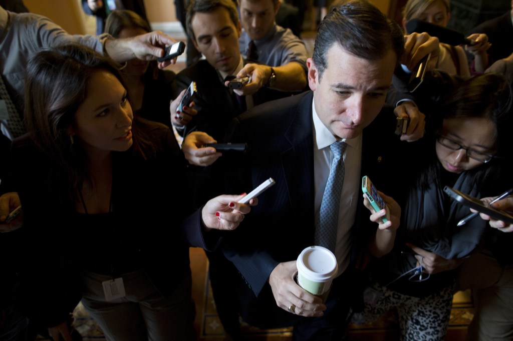 Sen. Ted Cruz, R-Texas, is followed by reporters as he walks to a Senate GOP meeting on Capitol Hill on Wednesday, Oct. 16, 2013 in Washington.