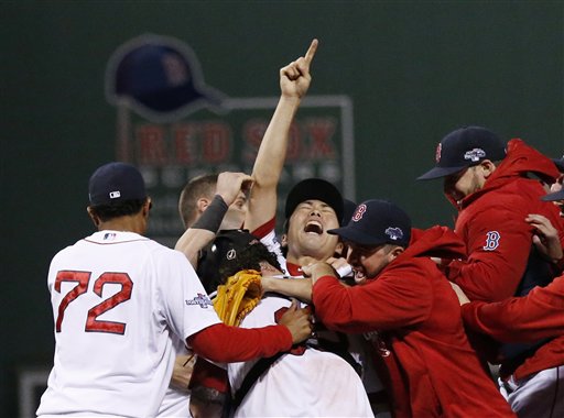 Boston Red Sox relief pitcher Koji Uehara, center, celebrates with teammates after the Red Sox beat the Detroit Tigers in Game 6 of the American League Championship Series on Saturdayin Boston.