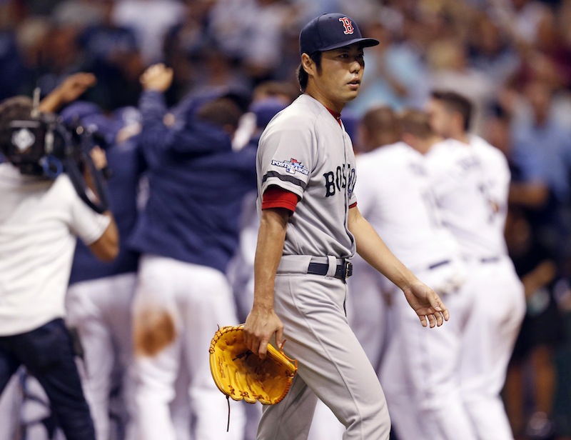 Boston Red Sox's relief pitcher Koji Uehara walks away as the Tampa Bay Rays celebrate the game winning home run by Jose Lobaton in the ninth inning in Game 3 of an American League baseball division series, Monday, Oct. 7, 2013, in St. Petersburg, Fla. (AP Photo/Mike Carlson) Tropicana Field