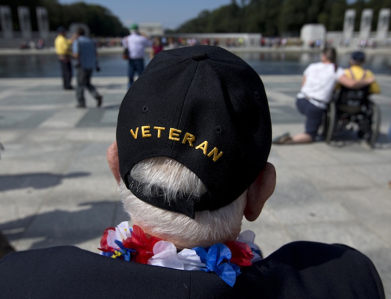 World War II Veteran George Bloss, from Gulfport, Miss., looks out over the National World War II Memorial in Washington, Tuesday, Oct. 1, 2013. Veterans who had traveled from across the country were allowed to visit the National World War II Memorial after it had been officially closed because of the partial government shutdown. After their visit, National World War II Memorial was closed again. (AP Photo/Carolyn Kaster)