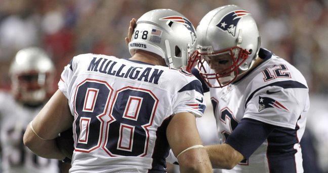 Patriots tight end Matt Mulligan celebrates with quarterback Tom Brady after scoring a touchdown in the first half Sunday night against the Atlanta Falcons.