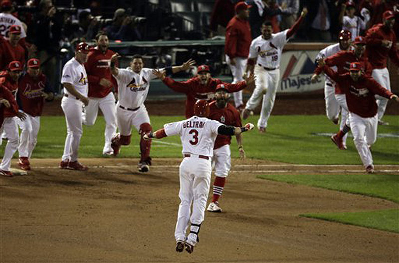 St. Louis Cardinals' Carlos Beltran celebrates with teammates after his game-winning hit in the 13th inning of Game 1 of the National League Campionship Series against the Los Angeles Dodgers on Saturday in St. Louis.