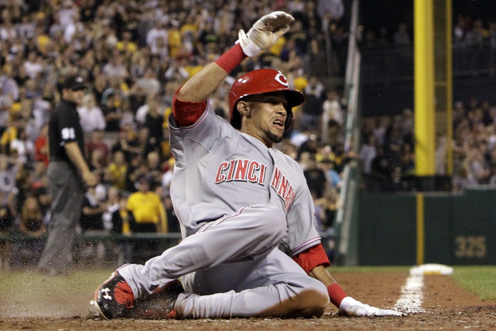 Cincinnati Reds’ Billy Hamilton scores the second of two runs on an infield single by Devin Mesoraco off Pittsburgh Pirates relief pitcher Mark Melancon during the ninth inning a baseball game in Pittsburgh on Friday, Sept. 20, 2013. The Reds won 6-5 in 10 innings.