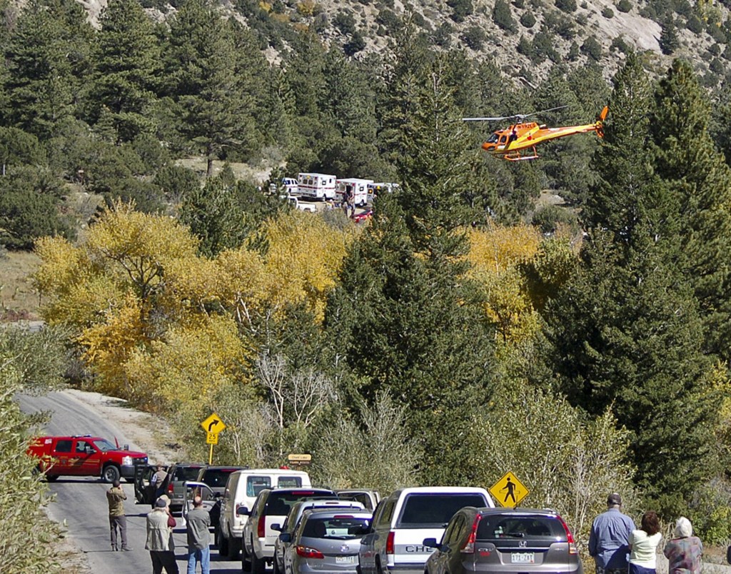 A Flight for Life Helicopter rises above backed up traffic Monday in south-central Colorado. Roads were closed as emergency personnel work to aid hikers trapped after a rock slide on the trail to Agnes Vaille Falls.