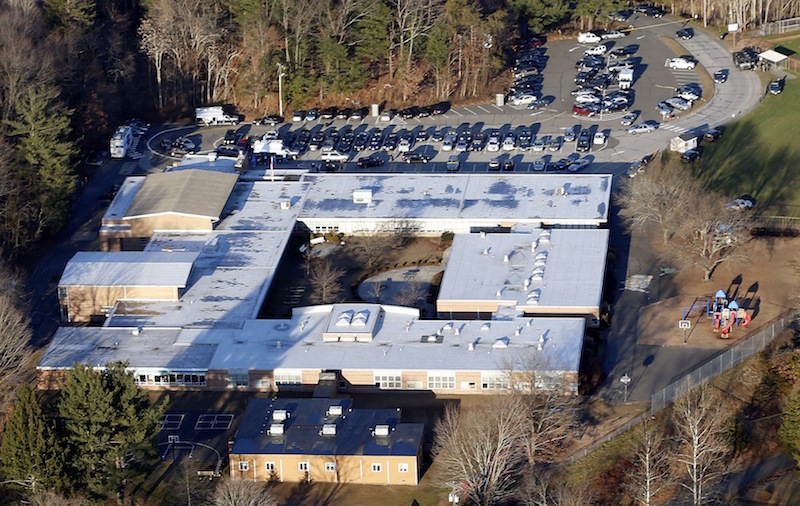 This Dec. 14, 2012 aerial file photo shows Sandy Hook Elementary School in Newtown, Conn. Contractors demolishing Sandy Hook Elementary School are being required to sign confidentiality agreements forbidding public discussion of the site, photographs or disclosure of any information about the building where 26 people were fatally shot in December 2012.