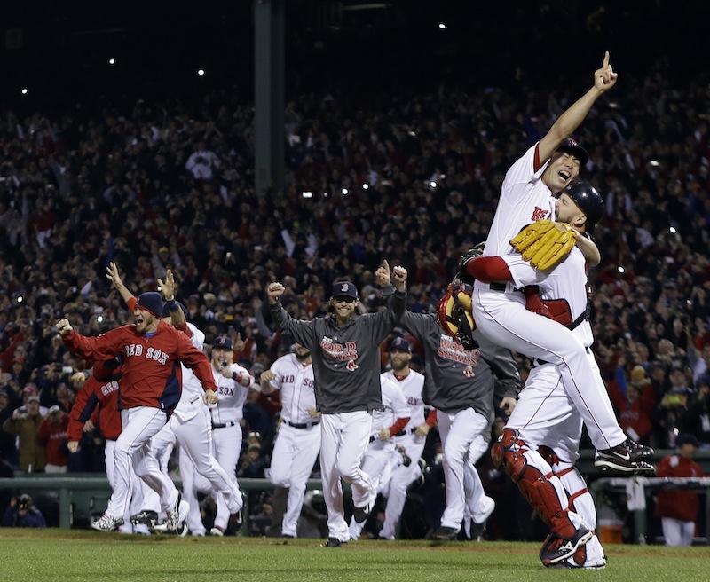 Boston Red Sox relief pitcher Koji Uehara and catcher David Ross celebrate after getting St. Louis Cardinals' Matt Carpenter to strike out and end Game 6 of baseball's World Series Wednesday, Oct. 30, 2013, in Boston. The Red Sox won 6-1 to win the series. MLB