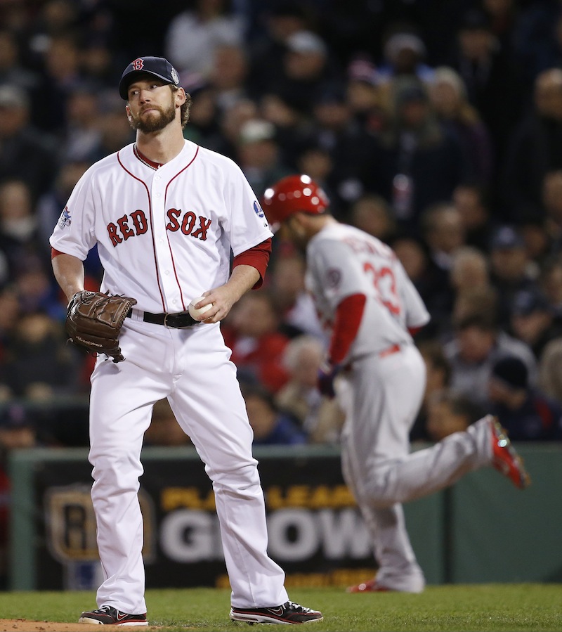 Boston Red Sox relief patcher Craig Breslow reacts after walking St. Louis Cardinals' Daniel Descalso, right, during the seventh inning of Game 2 of baseball's World Series Thursday, Oct. 24, 2013, in Boston. Breslow later made a costly error. MLB