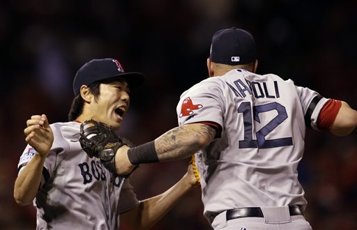 Boston Red Sox's Koji Uehara and Mike Napoli (12) celebrate after Game 4 of baseball's World Series against the St. Louis Cardinals Sunday, Oct. 27, 2013, in St. Louis. The Red Sox won 4-2 to ties the series at 2-2. (AP Photo/Jeff Roberson) MLB