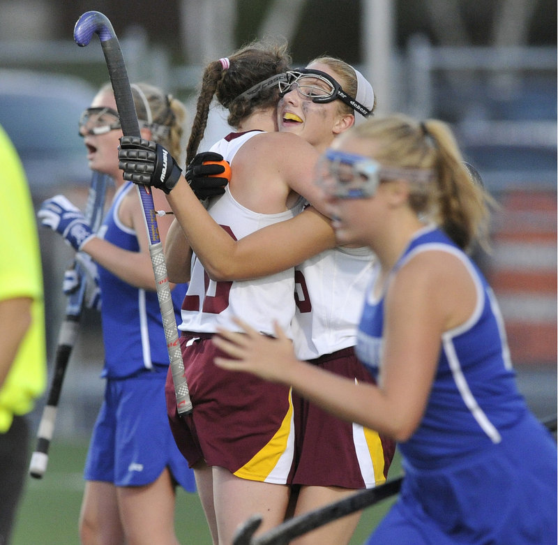 Taylor Herrera, right, gets a hug from teammate Megan Nicholson after scoring the only goal in Cape Elizabeth’s 1-0 victory over Kennebunk on Tuesday.