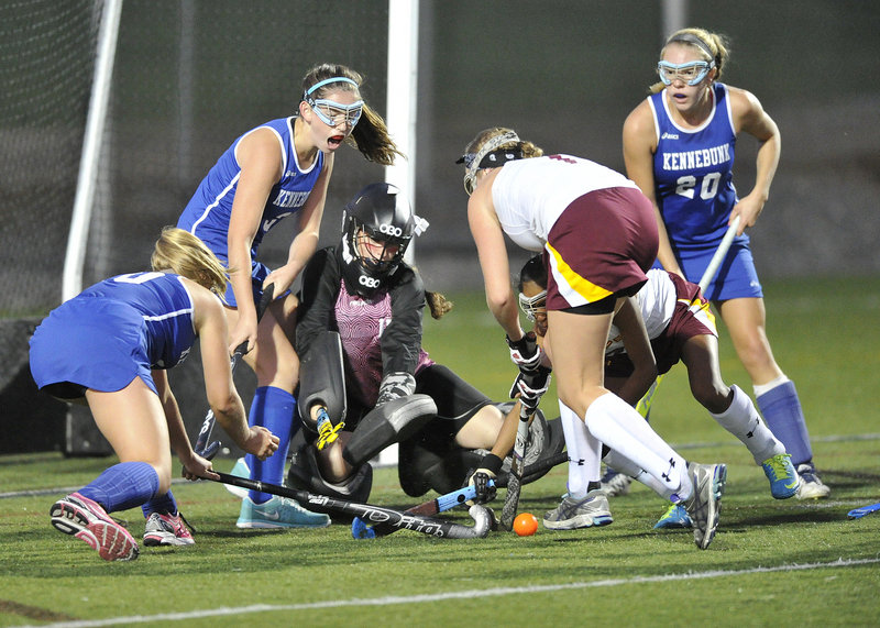 Cape Elizabeth goalkeeper Mary DiPietro keeps her eye on the ball while teammate Hailey Petsinger tries to clear it from a slew of Kennebunk players who never did find the back of the net in Tuesday’s game.