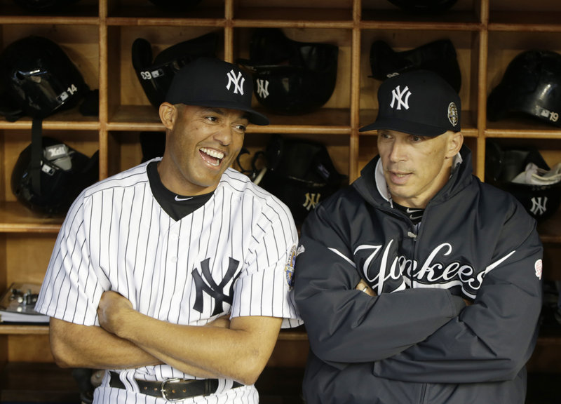 New York Yankees retiring closer Mariano Rivera shares a laugh with manager Joe Girardi. The Yankees want Girardi to continue managing the team even after this disappointing season.